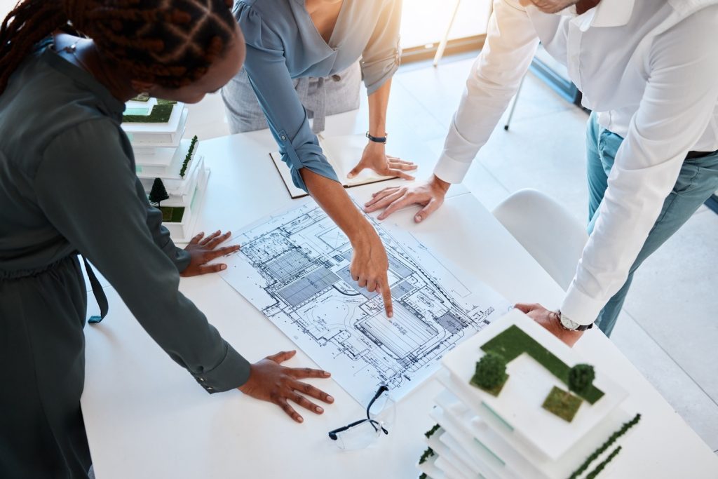 Architects and construction professionals reviewing project drawings as part of a UK construction marketing and SEO strategy