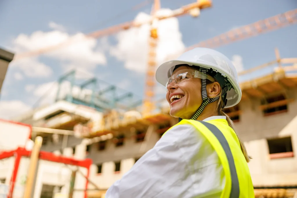 Smiling construction worker in a hard hat and hi-vis on site